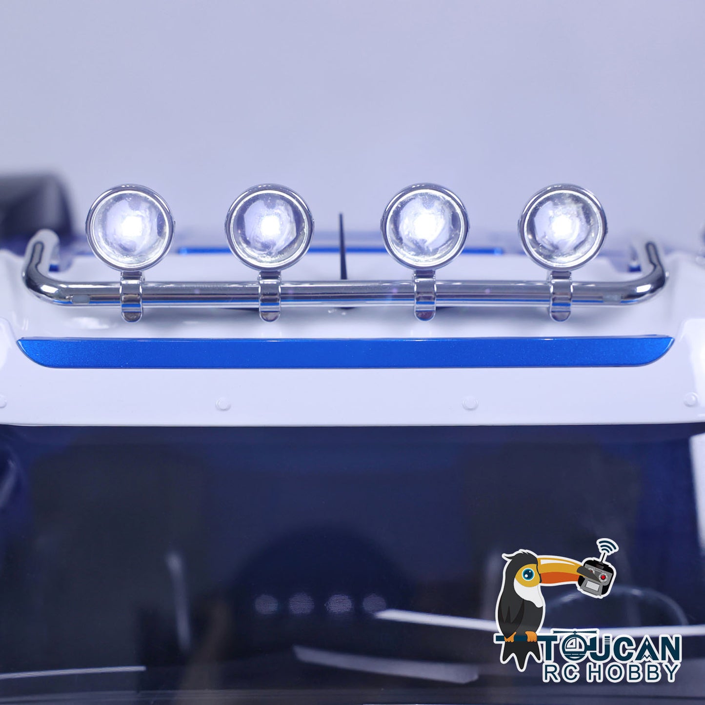 1/14 RC TOUCAN Truck LED headlight system detail with blue front lights and roof light bar