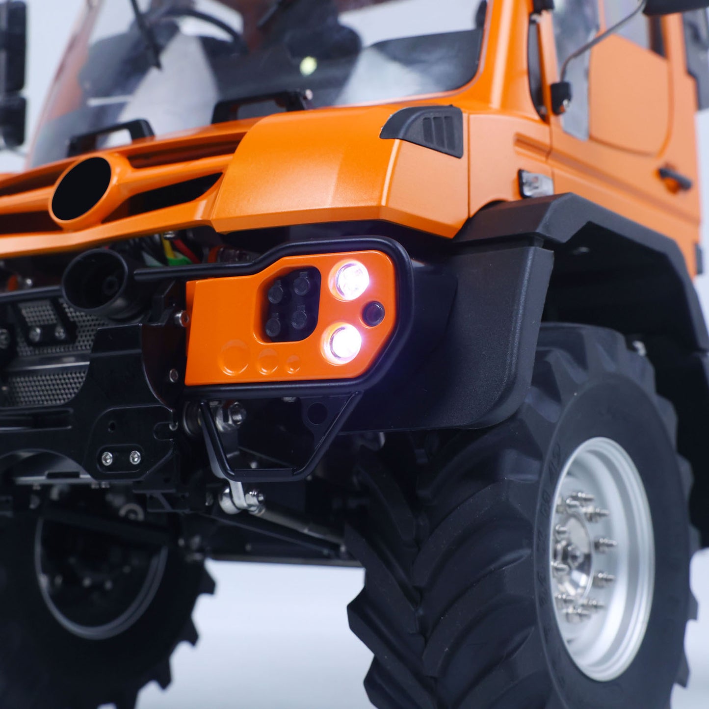 LikeRC U535Lite RC 4X4 Crawler Truck Orange Front Corner Close‑Up, Illuminated Headlight & Front Bumper Detail