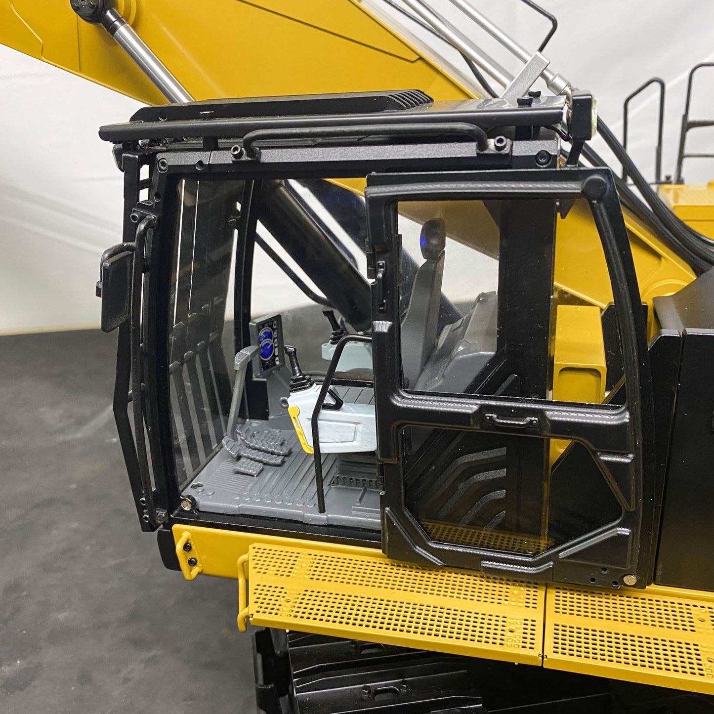 RC excavator chassis adjustable width metal track system close up detail