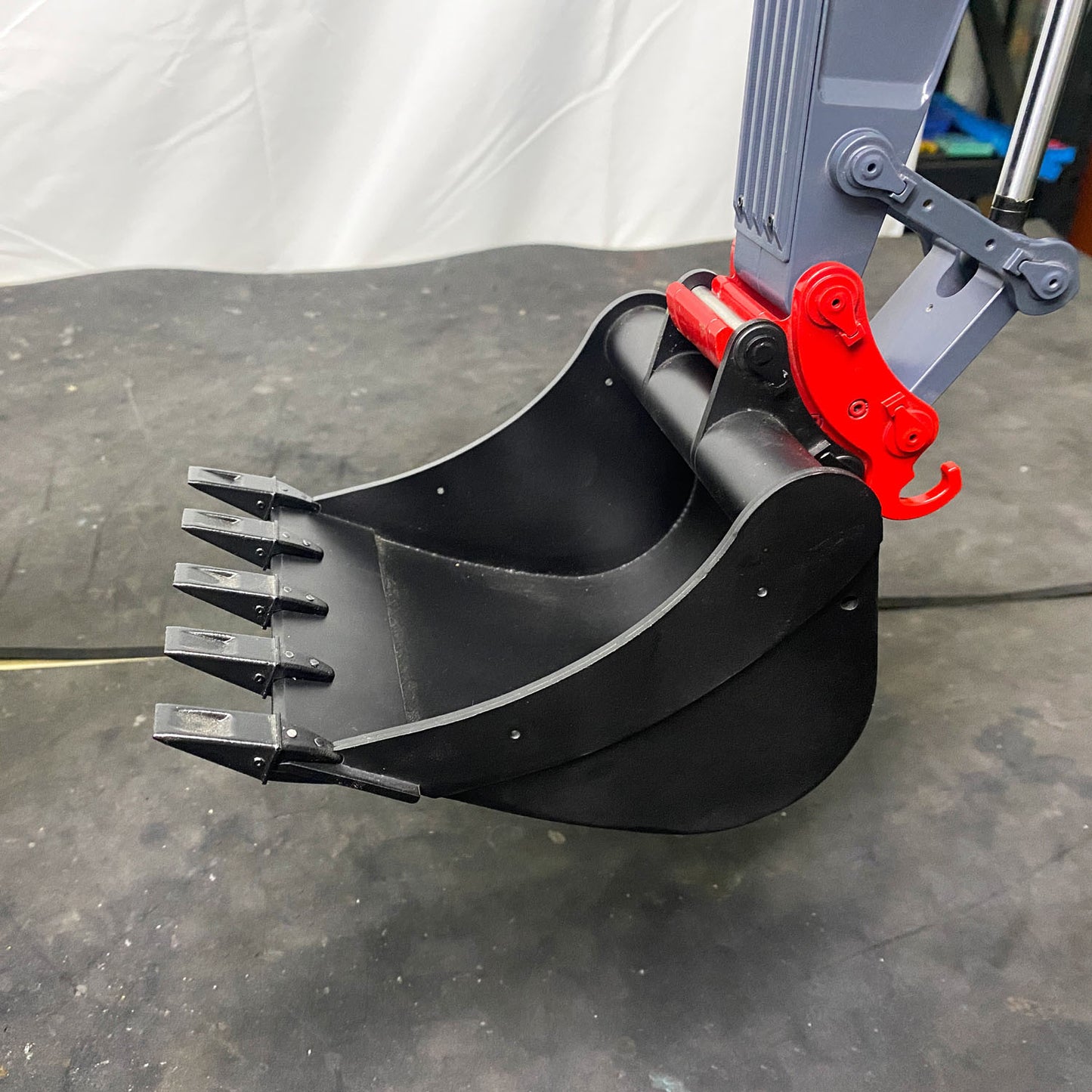 RC hydraulic excavator C374-UHD metal boom cylinder and hydraulic bucket close up detail